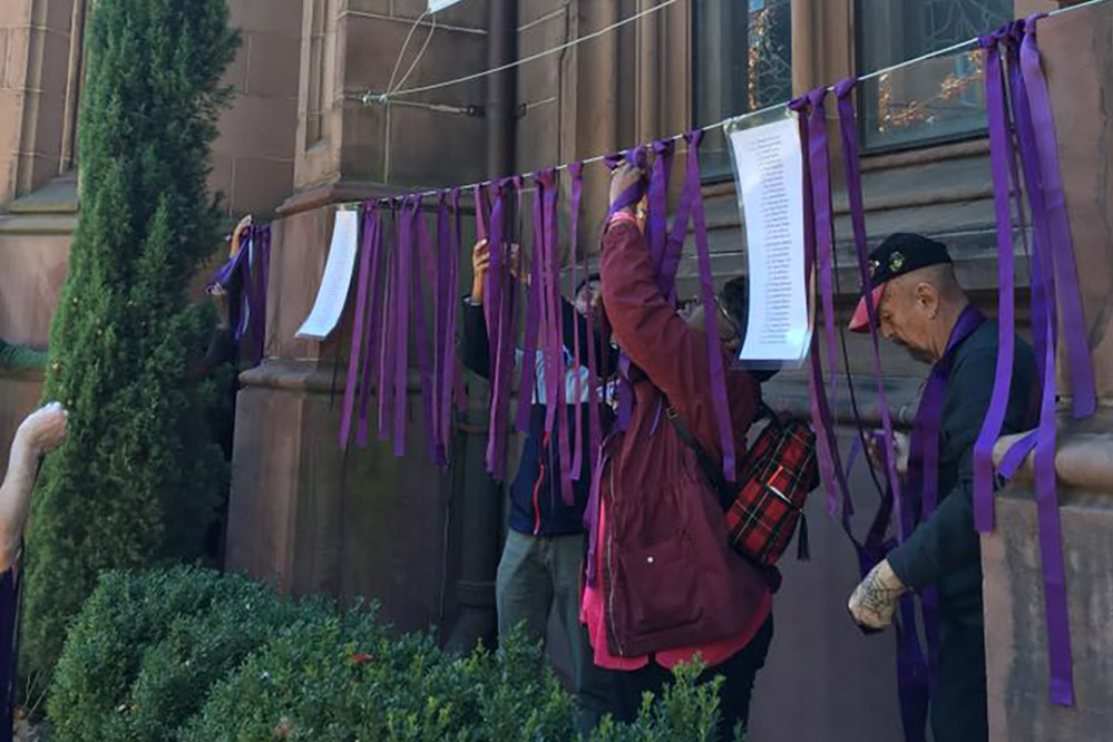 Tying purple ribbons outide the sanctuary.